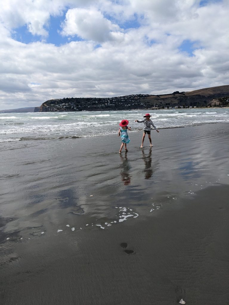 kids on a beach in new zealand